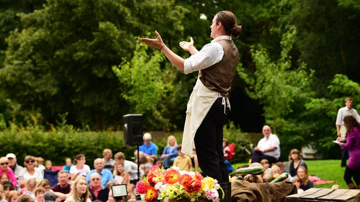 An outdoor theatre performance taking place in the gardens